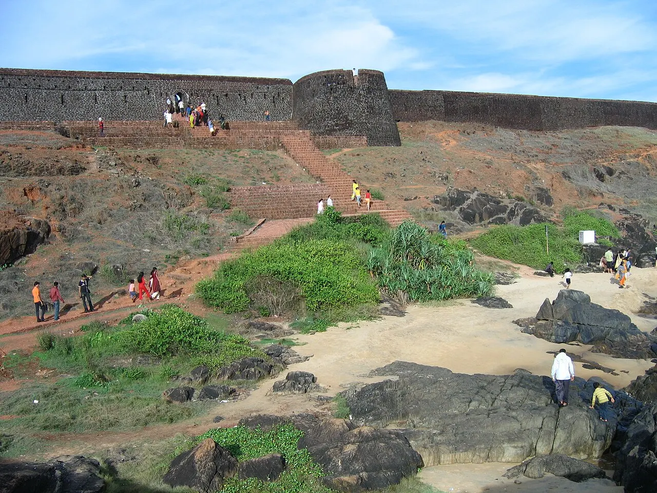 Bekal Fort's laterite walls rising above the beach, Kasaragod, Kerala